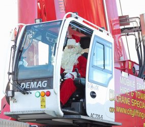 Man dressed as Father Christmas in cab of crane