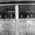 Soldiers looking out of window with words 'DEUTSCHE GEFANGENE’ underneath